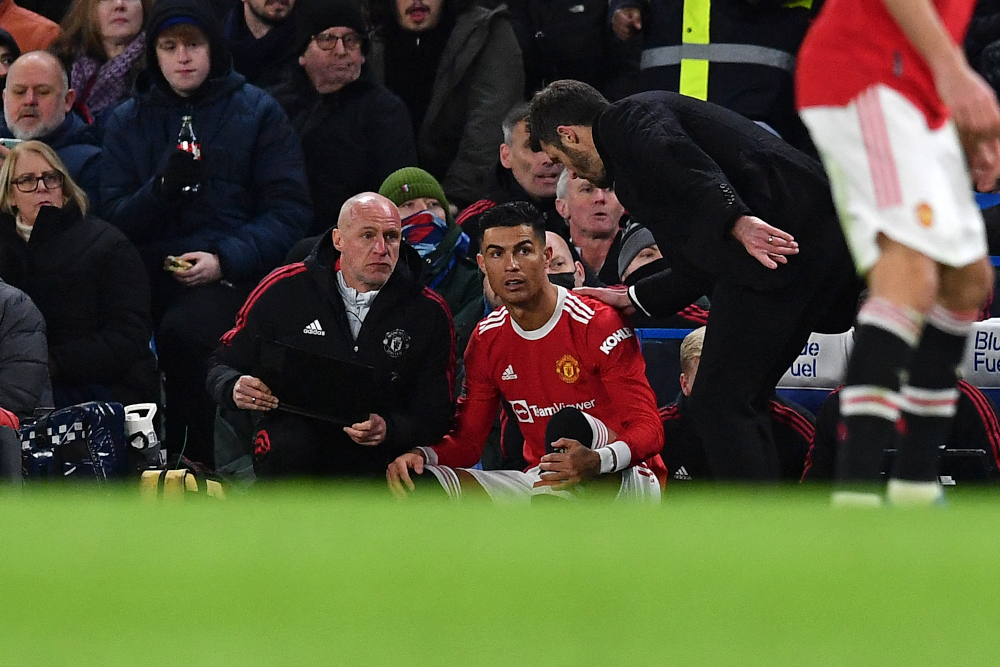 Manchester United striker Cristiano Ronaldo prepares to come off the bench as caretaker manager Michael Carrick talks to him during the English Premier League match against Chelsea at Stamford Bridge in London, November 28, 2021. u00e2u20acu201d AFP pic