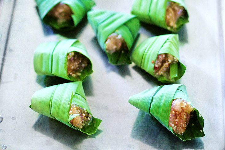 Rows of stuffed pandan chicken parcels ready for frying.
