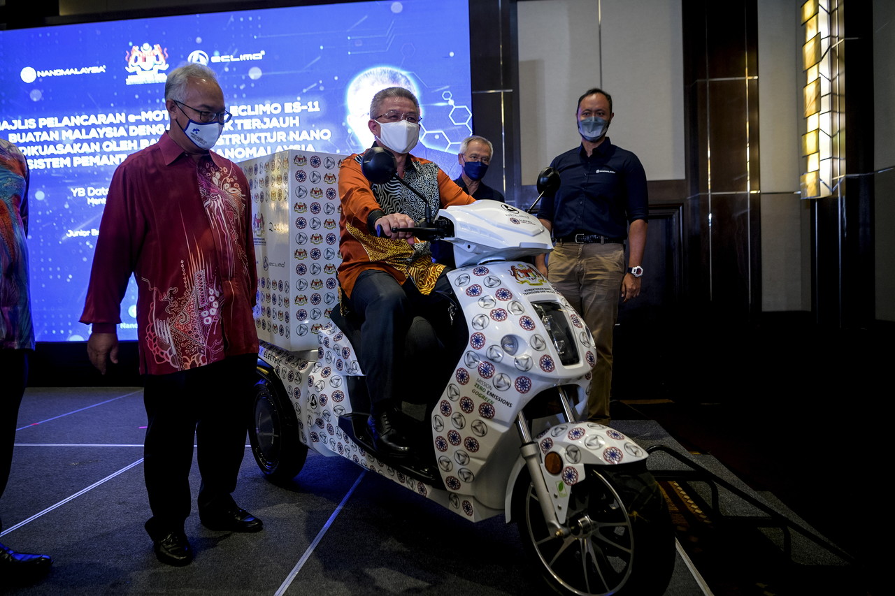 Science, Technology and Innovation Minister Datuk Seri Dr Adham Baba (centre) launches the ES-11 electric motorcycle equipped with a nano-structured battery monitoring system, Dec 9, 2021. u00e2u20acu201d Bernama pic