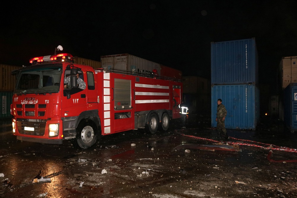 A firefighting vehicle is parked at a container storage area, after Syrian state media reported an Israeli air strike on the Syrian port of Latakia, Syria, in this handout picture released by SANA on December 7, 2021. u00e2u20acu2022 SANA/Handout via Reuters