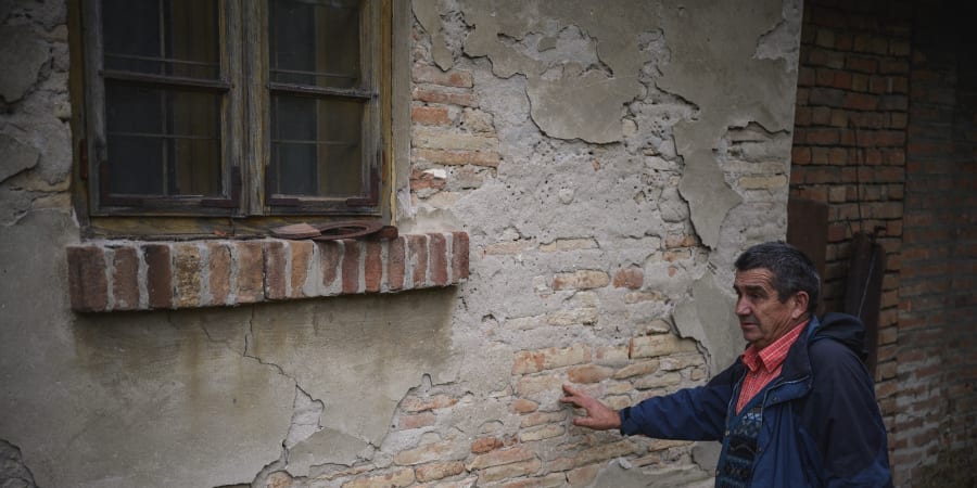 Dragan Jacanovic, an archeologist from the Museum of Pozarevac, shows the ancient Roman bricks in a wall of a house, in central Serbiau00e2u20acu2122s Stari Kostolac. u00e2u20acu201d ETX Studio pic