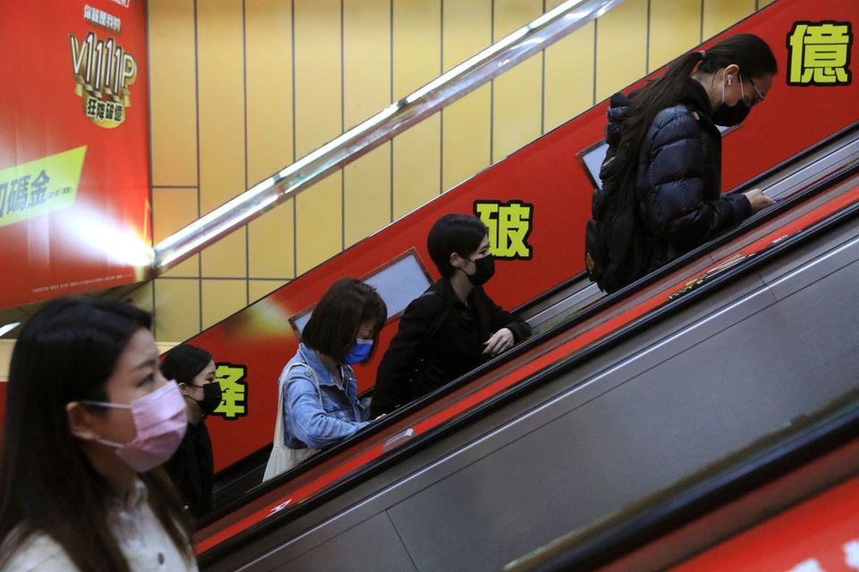 People wearing masks to prevent the spread of the coronavirus disease (Covid-19) ride on an escalator during morning rush hour at a subway station in Taipei, Taiwan, November 30, 2021. u00e2u20acu201d Reuters