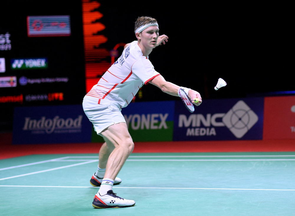 Denmarku00e2u20acu2122s Viktor Axelsen hitting a return against Singaporeu00e2u20acu2122s Loh Kean Yew during their men's singles final badminton match at the Indonesia Open in Nusa Dua in Bali, November 28, 2021. u00e2u20acu201d Badminton Association of Indonesia handout pic via AFPnn