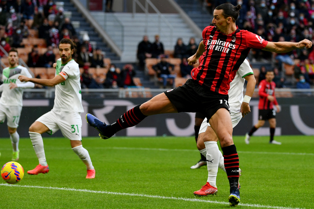 AC Milan forward Zlatan Ibrahimovic fights for the ball with Sassuolo defender Gian Marco Ferrari during the Italian Serie A football at the San Siro stadium in Milan, November 28, 2021. u00e2u20acu201d AFP pic