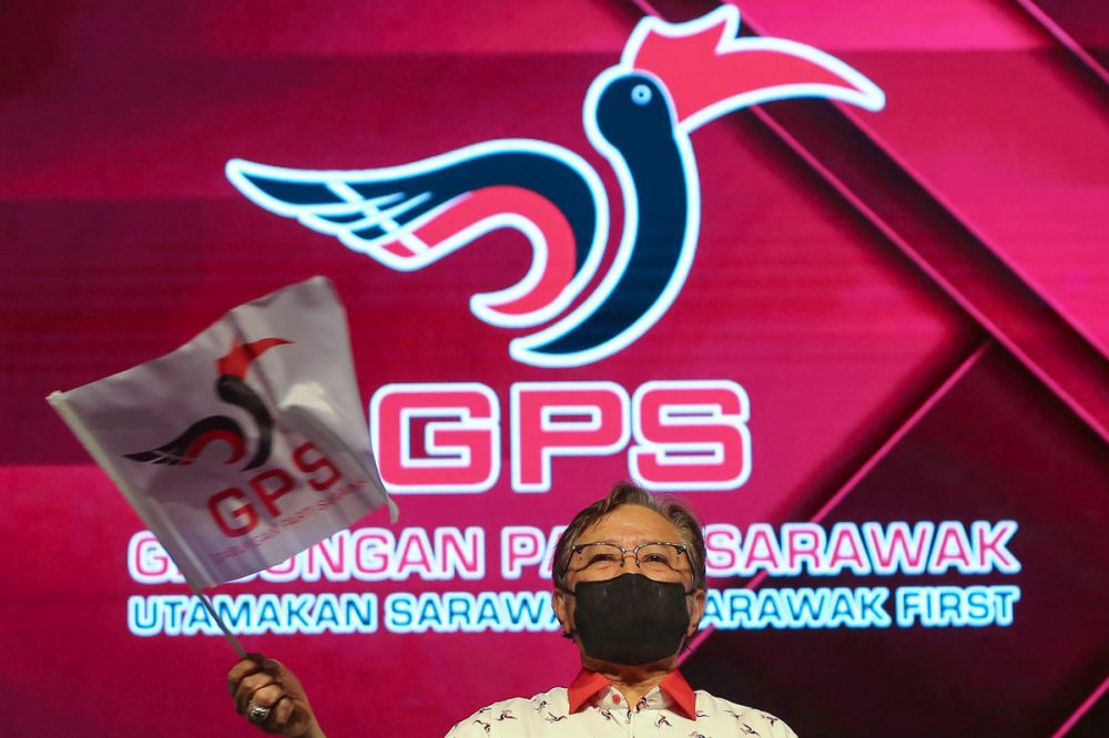 Gabungan Parti Sarawak chairman Tan Sri Abang Johari Openg waves a party flag at the Borneo Convention Centre, Kuching December 18, 2021. u00e2u20acu2022 Picture by Yusof Mat Isa