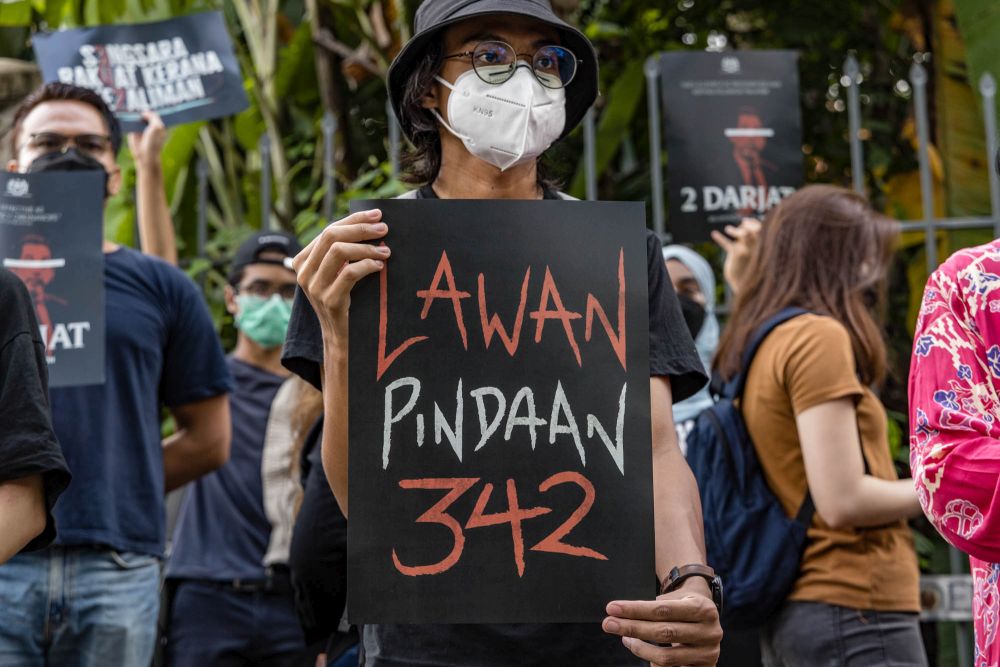 Activists hold aloft placards protesting amendments to Act 342 in Kuala Lumpur December 16, 2021. u00e2u20acu201d Picture by Shafwan Zaidon