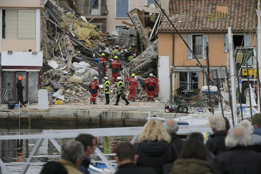 Pedestrians watch as French firefighters search the rubble for missing inhabitants after a building collapsed in Sanary-sur-Mer, on December 7, 2021. u00e2u20acu201d AFP pic