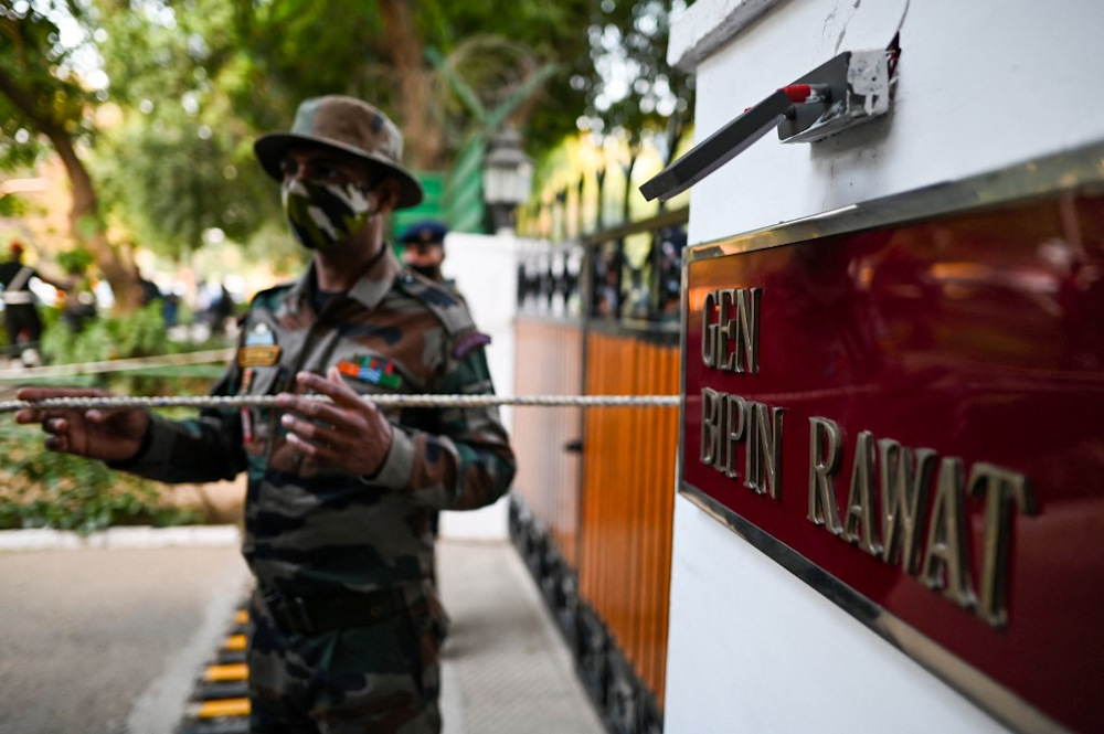 Security personnel stand guard outside the entrance of defence chief General Bipin Rawat’s house in New Delhi on December 8, 2021. — AFP pic