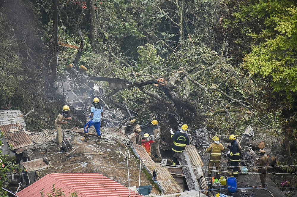 Firemen undertake rescue operation next to the debris of an IAF Mi-17V5 helicopter crash site in Coonoor, Tamil Nadu, on December 8, 2021. u00e2u20acu201d AFP pic