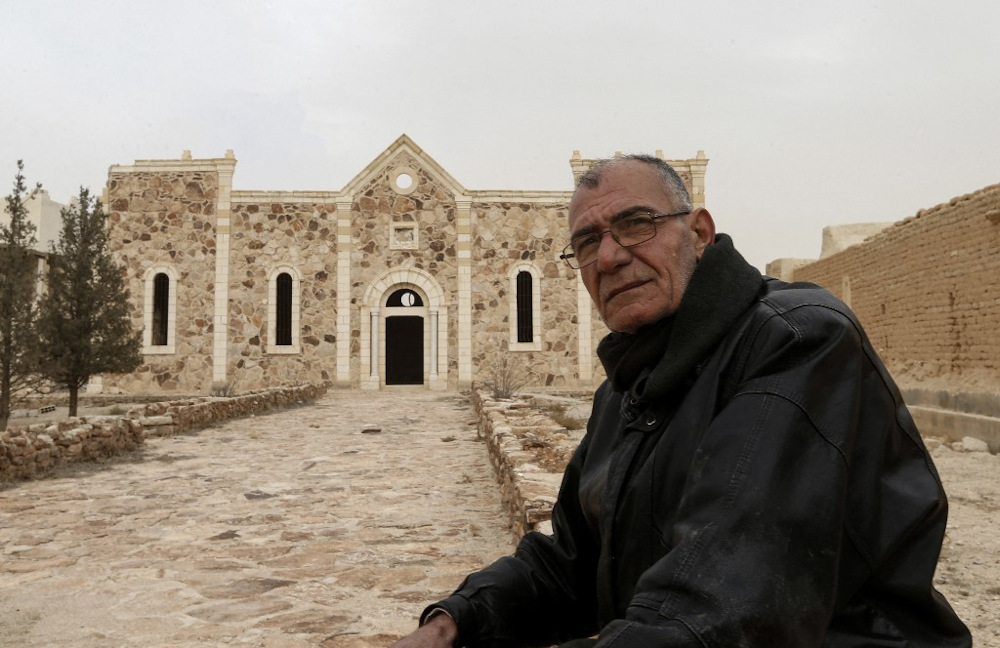 Matanios Dalloul, 62, one of the 20 remaining Christian residents of the central Syrian town of al-Qaryatain, sits in front of the fifth-century Syriac Catholic monastery of Mar Elian (Saint Elian) on December 20, 2021. u00e2u20acu201d AFP pic