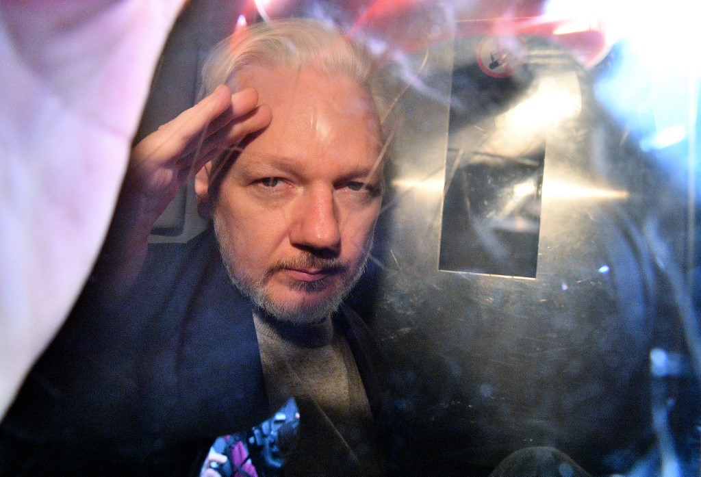 In this file photo taken on May 01, 2019, WikiLeaks founder Julian Assange gestures from the window of a prison van as he is driven out of Southwark Crown Court in London. u00e2u20acu201d AFP pic