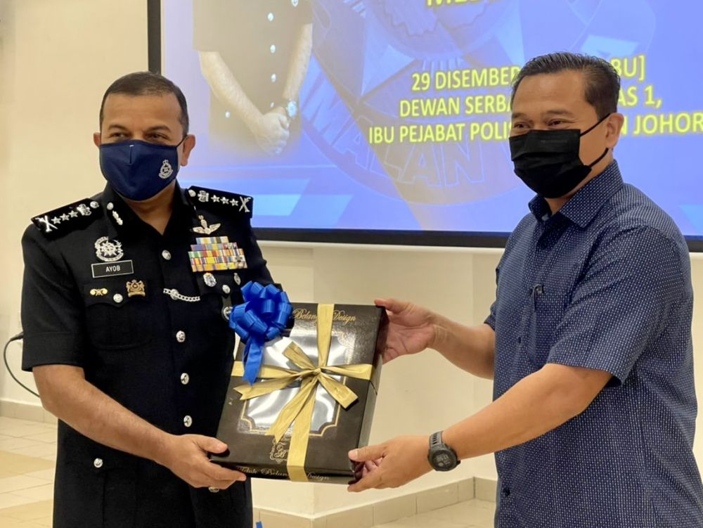 Datuk Ayob Khan Mydin Pitchay (right) receives a memento from Johor Media Club president Mohamad Fauzi Ishak at the Johor police contingent headquarters in Johor Baru December 29, 2021. u00e2u20acu201d Picture by Ben Tan