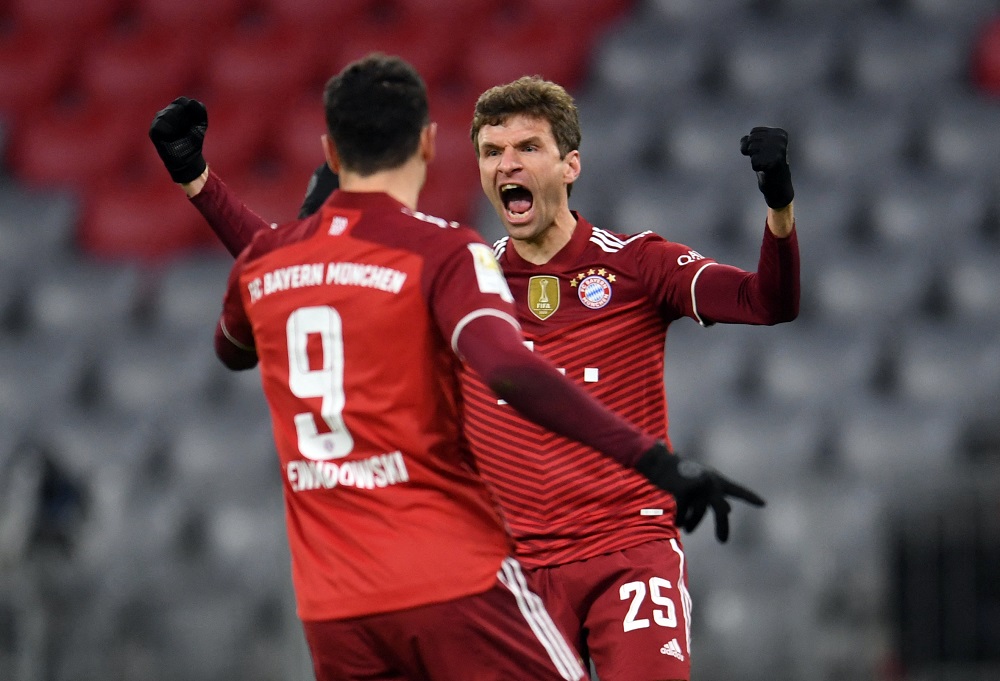 Bayern Munich's Thomas Muller celebrates with Robert Lewandowski after scoring the first goal against Wolfsburg December 18, 2021. u00e2u20acu2022 Reuters pic