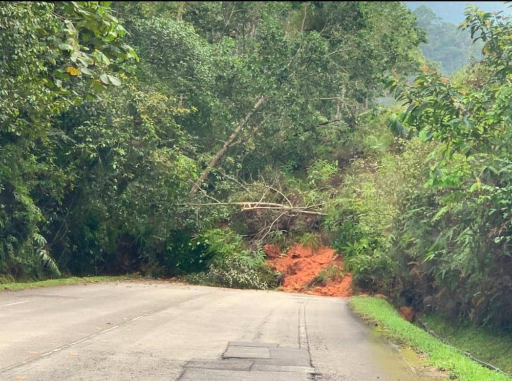 A vehicle buried under the fallen earth from the landslide in Cameron Highlands along Section 27 of Jalan Simpang Pulai-Cameron Highlands, December 2, 2021. u00e2u20acu201d Picture courtesy of the Perak Fire and Rescue Department