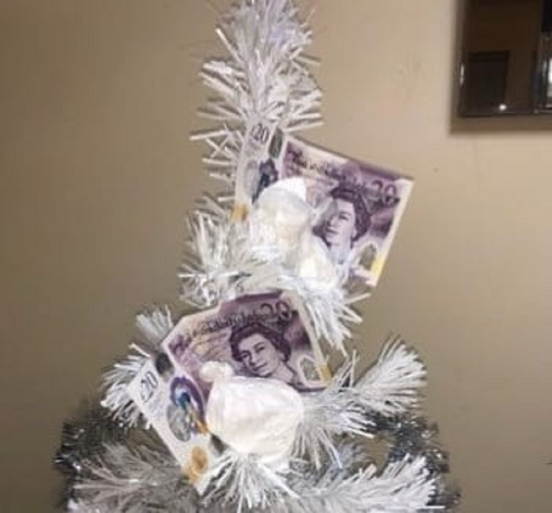 A drug dealer has taken the extra mile to decorate his Christmas tree with cash and white powder. u00e2u20acu2022 Picture via Twitter/ @MerseyPolice 