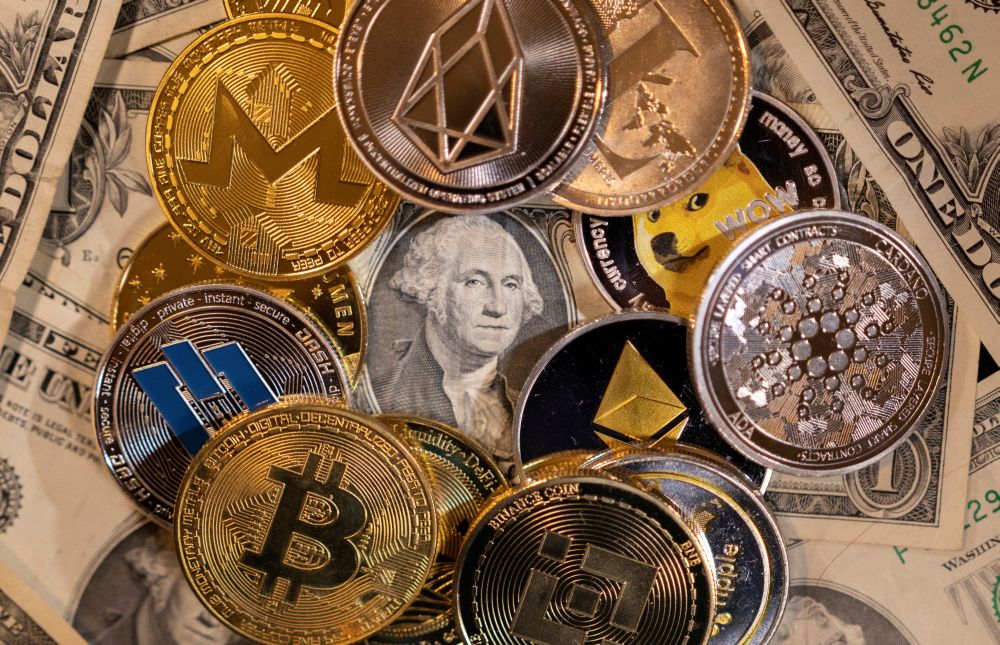 Representations of virtual cryptocurrencies are placed on US Dollar banknotes in this illustration taken November 28, 2021. u00e2u20acu201d AFP pic