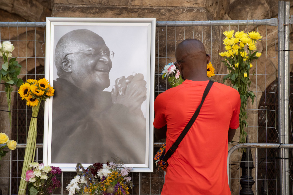 A mourner brings flowers to St Georges Cathedral, where a Wall of Remembrance for South African anti-apartheid icon Archbishop Desmond Tutu has been set up after the news of his death, in Cape Town, December 26, 2021. u00e2u20acu201d AFP pic 