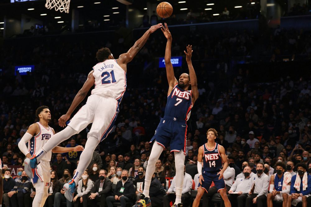 Brooklyn Nets forward Kevin Durant (7) shoots the ball as Philadelphia 76ers center Joel Embiid (21) defends during the second half at Barclays Centre in Brooklyn December 16, 2021. u00e2u20acu201d Reuters picnn