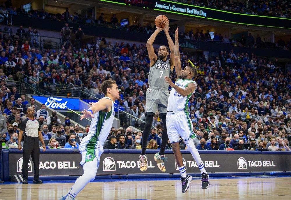 Brooklyn Nets forward Kevin Durant (7) shoots over Dallas Mavericks center Dwight Powell (7) and forward Reggie Bullock (25) during the second half at the American Airlines Centre, Dallas December 7, 2021. u00e2u20acu2022 Reuters pic