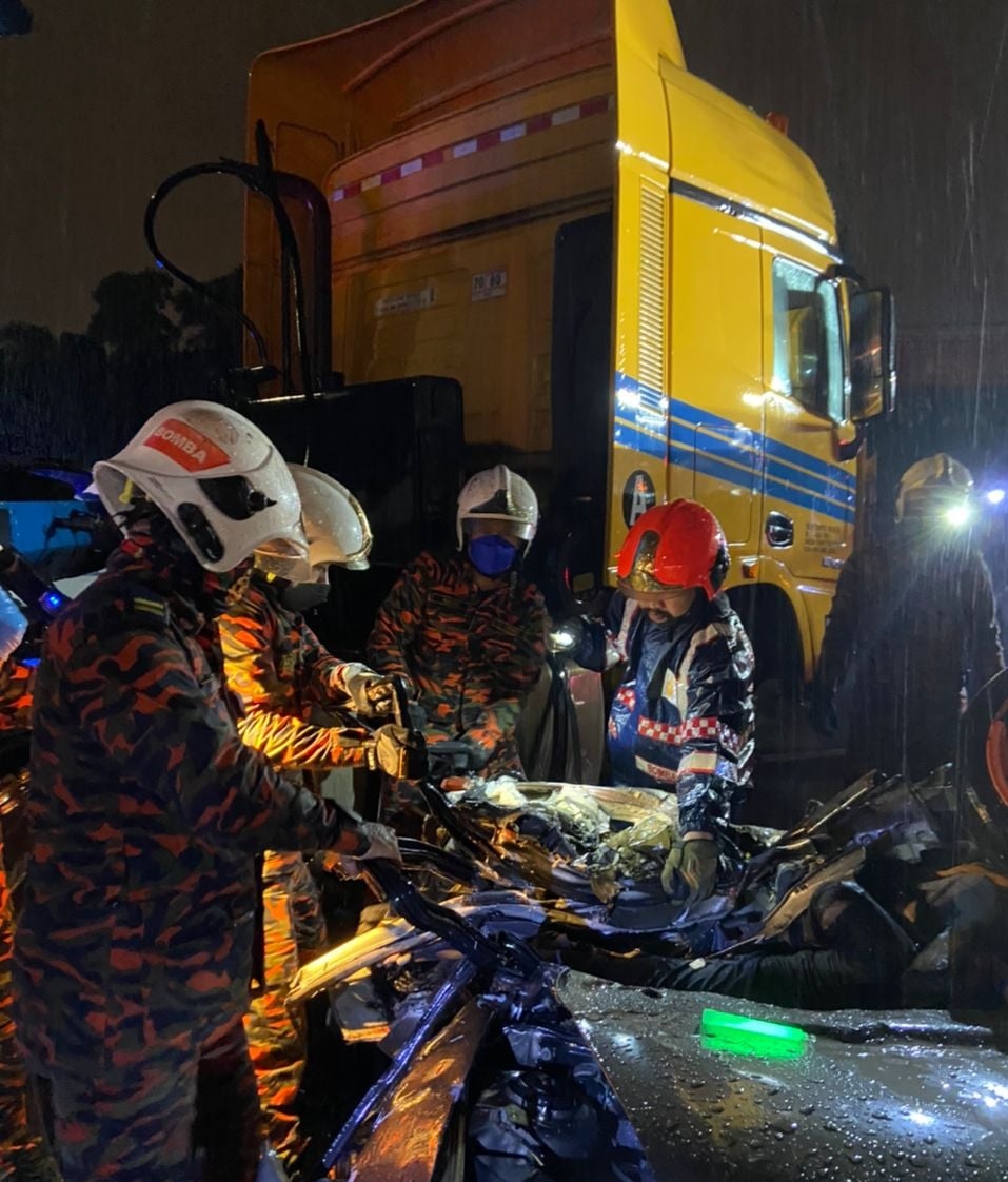Fire and Rescue Department personnel working at the scene of the accident. u00e2u20acu2022 Picture via Facebook/Bernama