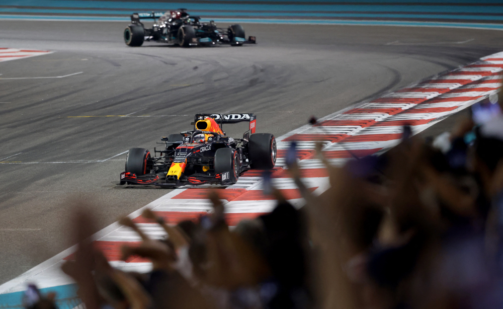 Red Bull driver Max Verstappen about to cross the finish line followed by Mercedes driver Lewis Hamilton at the Yas Marina Circuit during the Abu Dhabi Formula One Grand Prix, December 12, 2021. u00e2u20acu201d AFP pic 