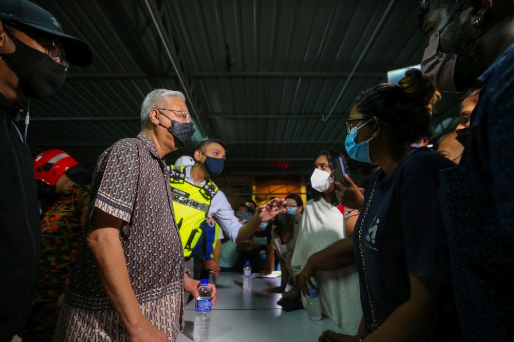Prime Minister Datuk Ismail Sabri Yaakob speaks to residents of Sri Johor Flats after a fire broke out there on December 19, 2021. u00e2u20acu201d Picture by Hari Anggara