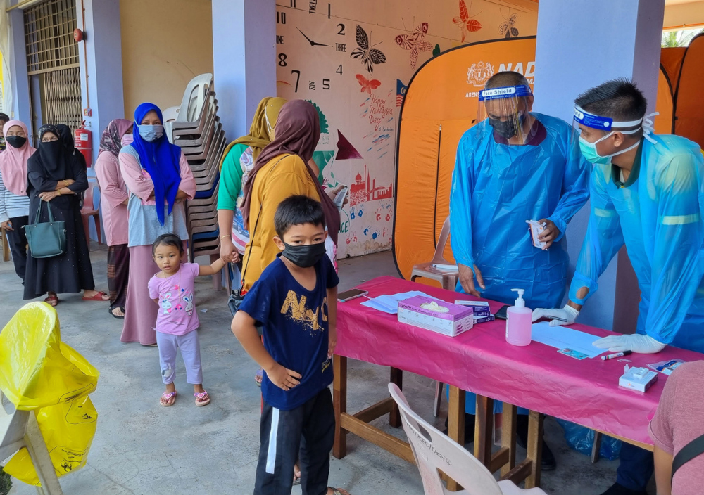Flood victims who registered to stay at a temporary relief centre undergo Covid-19 screening by Health Ministry personnel at SK Tok Deh near Rantau Panjang in Kelantan, December 22, 2021. u00e2u20acu201d Bernama pic