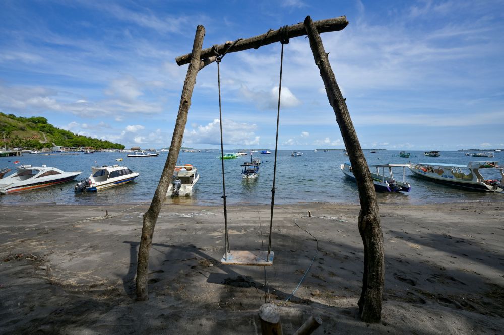 A swing is seen near boats anchored along the shore in Pemenang on North Lombok island, where tourists used to take the ferry to Gili Trawangan resort island November 22, 2021. u00e2u20acu201d AFP pic