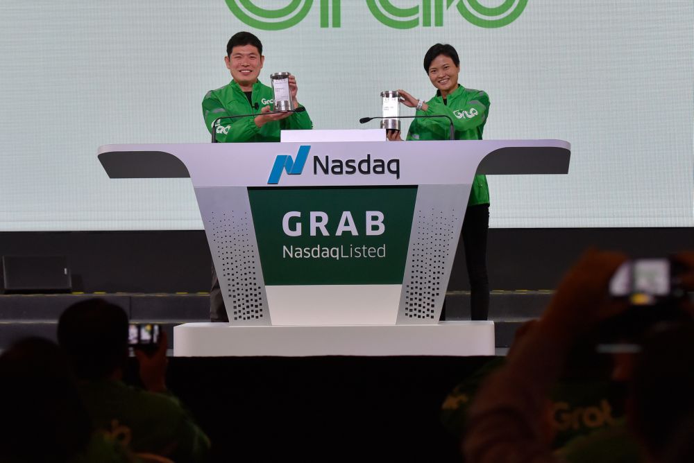 Grab's CEO Anthony Tan and co-founder Tan Hooi Ling pose for photos with the Nasdaq Crystal they received at the Grab Bell Ringing Ceremony, at a hotel in Singapore December 2, 2021. u00e2u20acu201d Reuters pic