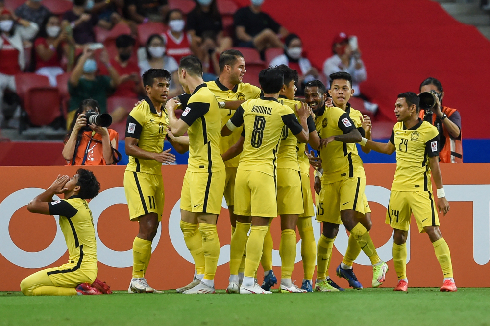 Malaysiau00e2u20acu2122s Kogileswaran Raj Mohana Raj (3rd right) celebrates with teammates after scoring a goal during the AFF Suzuki Cup 2020 Group B football match between Malaysia and Indonesia at the National Stadium in Singapore, December 19, 2021. u00e2u20acu201d AFP picnn