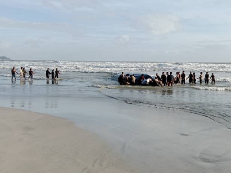 Undocumented migrants were discovered by the Malaysian Army personnel together with their wrecked boat on the Tanjung Balau beach in Kota Tinggi December 15, 2021. u00e2u20acu201d Picture courtesy of the Malaysian Maritime Enforcement Agency