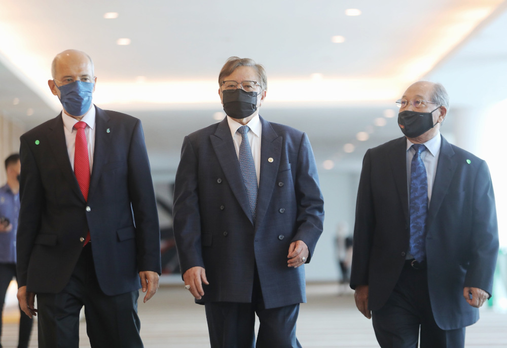 Tan Sri Abang Johari Openg (centre), Petronas chairman Tan Sri Datuk Seri Mohd Bakke (left) and Petros chairman Tan Sri Datuk Amar Hamid Bugo (right) arrive for the MOU signing event December 11, 2021. u00e2u20acu201d Borneo Post pic