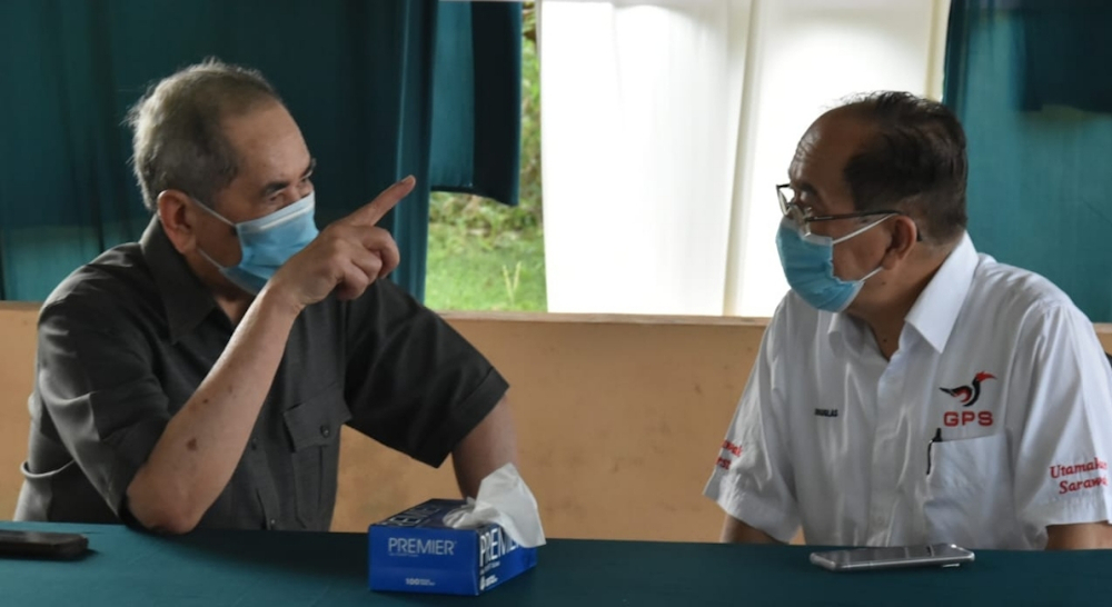 Datuk Seri Wan Junaidi Tuanku Jaafar (left) in a discussion with Datuk Douglas Uggah Embas. u00e2u20acu201d Borneo Post pic