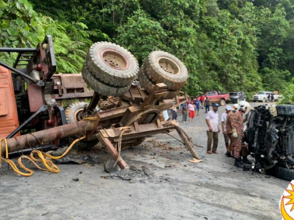 The Fire and Rescue Department (Bomba) photo showing both vehicles to their sides. u00e2u20acu201d Bomba pic via Borneo Post