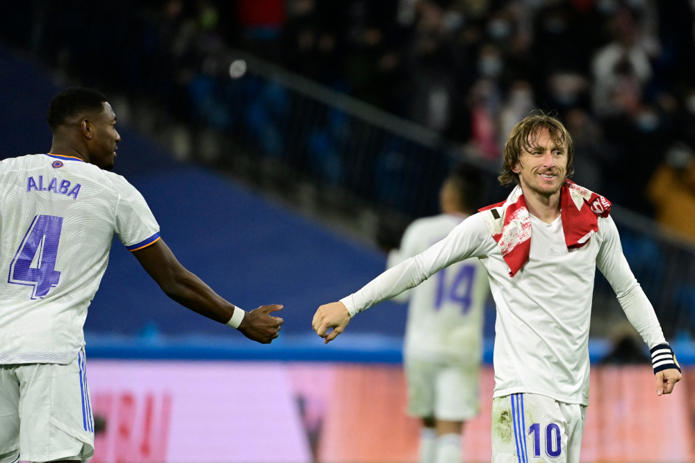Real Madridu00e2u20acu2122s David Alaba and Luka Modric celebrate at the end of the Spanish league football match against Club Atletico de Madrid at the Santiago Bernabeu stadium in Madrid, December 12, 2021. u00e2u20acu201d AFP pic 