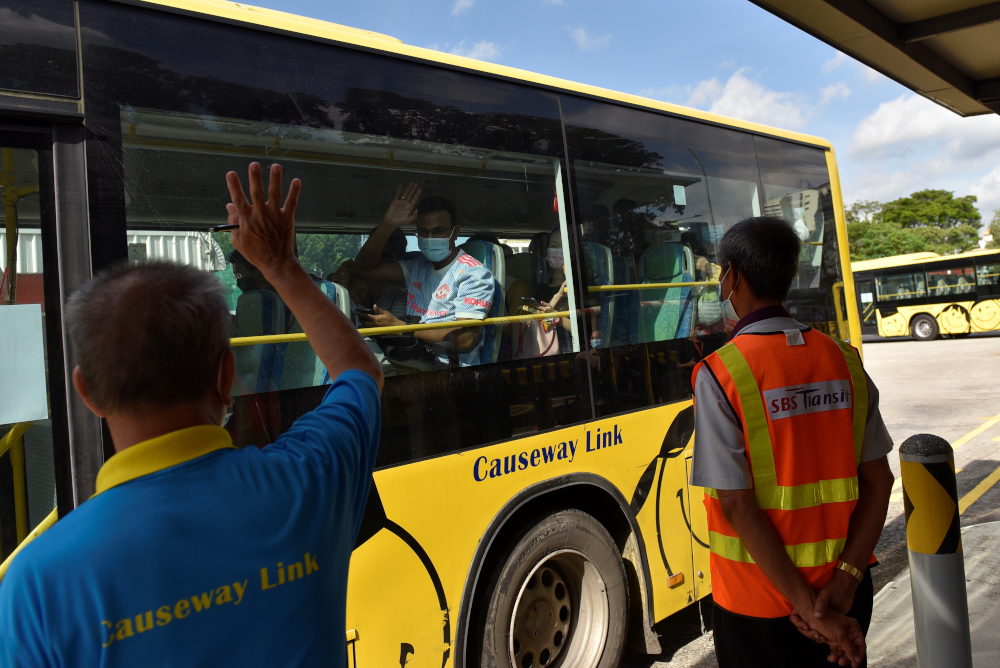 People leave on a bus back to Malaysia as the Vaccinated Travel Lane between Singapore and Malaysia opens after the land border between the two countries reopened, at a bus station in Singapore November 29, 2021. u00e2u20acu201d Reuters pic 