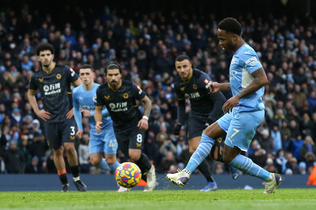 Manchester Cityu00e2u20acu2122s Raheem Sterling (right) takes a penalty and scores his teamu00e2u20acu2122s opening goal during the English Premier League match between Manchester City and Wolverhampton Wanderers at the Etihad Stadium in Manchester, December 11, 2021. u00e2u20acu201d AFP pi