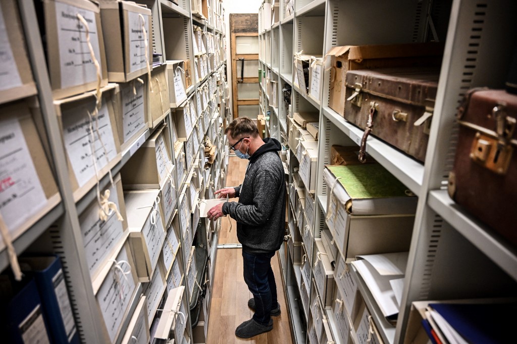 File photo taken on November 15, 2021 shows an employee inspecting archive documents at the office of rights group Memorial in Moscow. u00e2u20acu201d AFP pic