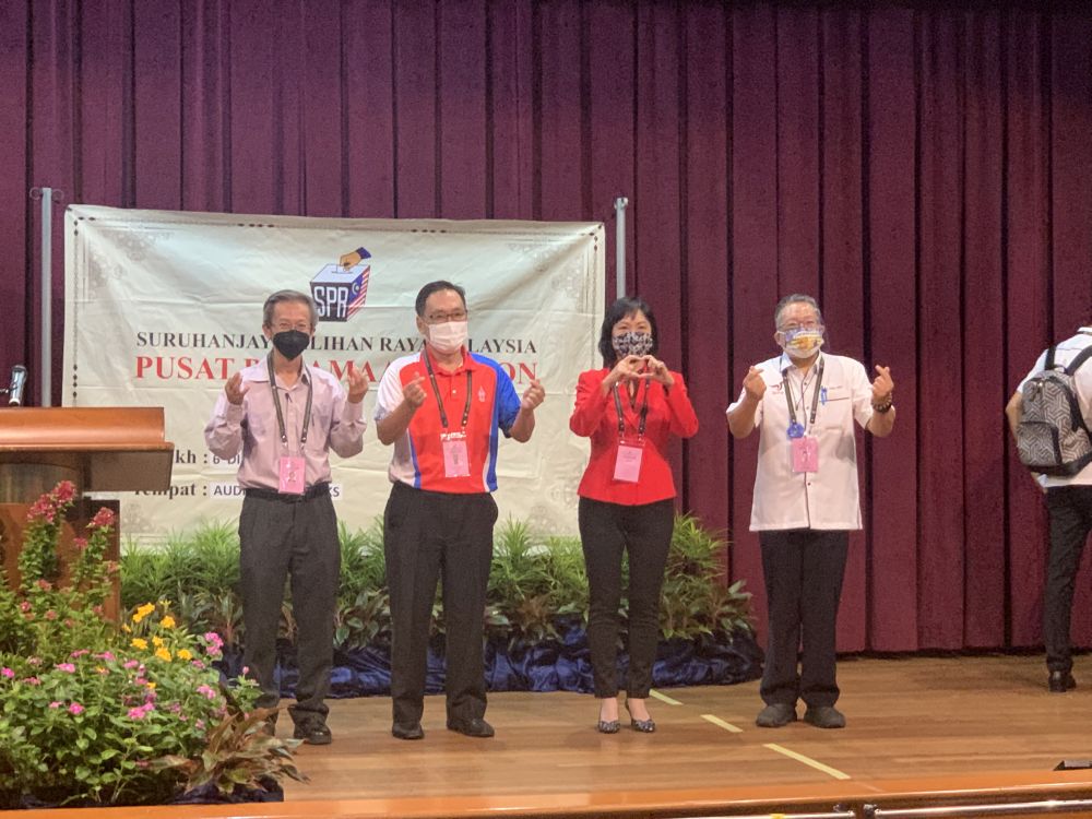 Padungan candidates (from left) Raymond Thong, Chong Chien Jen, Lina Soo and Datuk Wee Hong Seng pose for the cameras at the MBKS Hall nomination centre December 6, 2021. u00e2u20acu201d Picture by Radzi Razaknn
