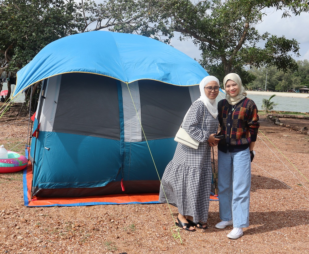 Campers enjoying the view and breeze of the sea near their campsite in PD. ― Picture by Anne Grace Savitha