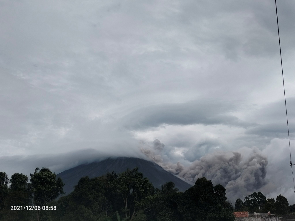 Ash and smoke move down the side of Mount Semeru volcano during an eruption, in Lumajang, East Java province December 6, 2021, in this photo obtained via social media. u00e2u20acu201d Twitter @kentarockerss pic via Reuters