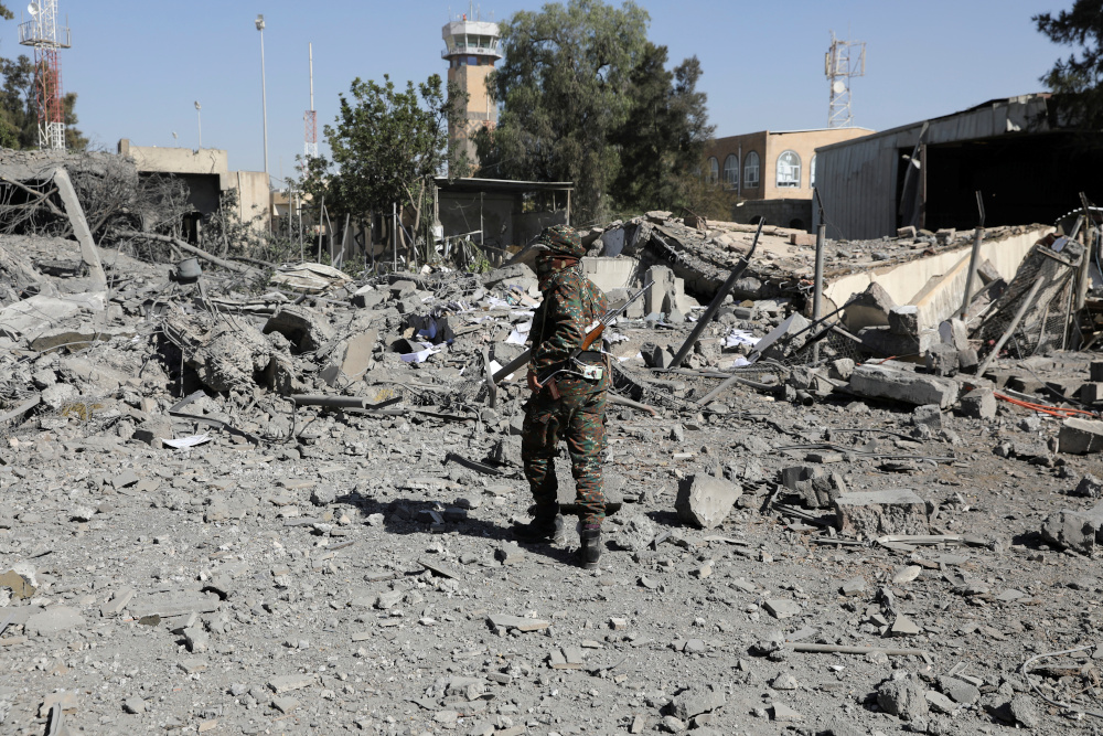 A police trooper walks on the rubble of a building destroyed by Saudi-led air strikes at Sanaa Airport in Sanaa, Yemen December 21, 2021. u00e2u20acu201d Reuters pic