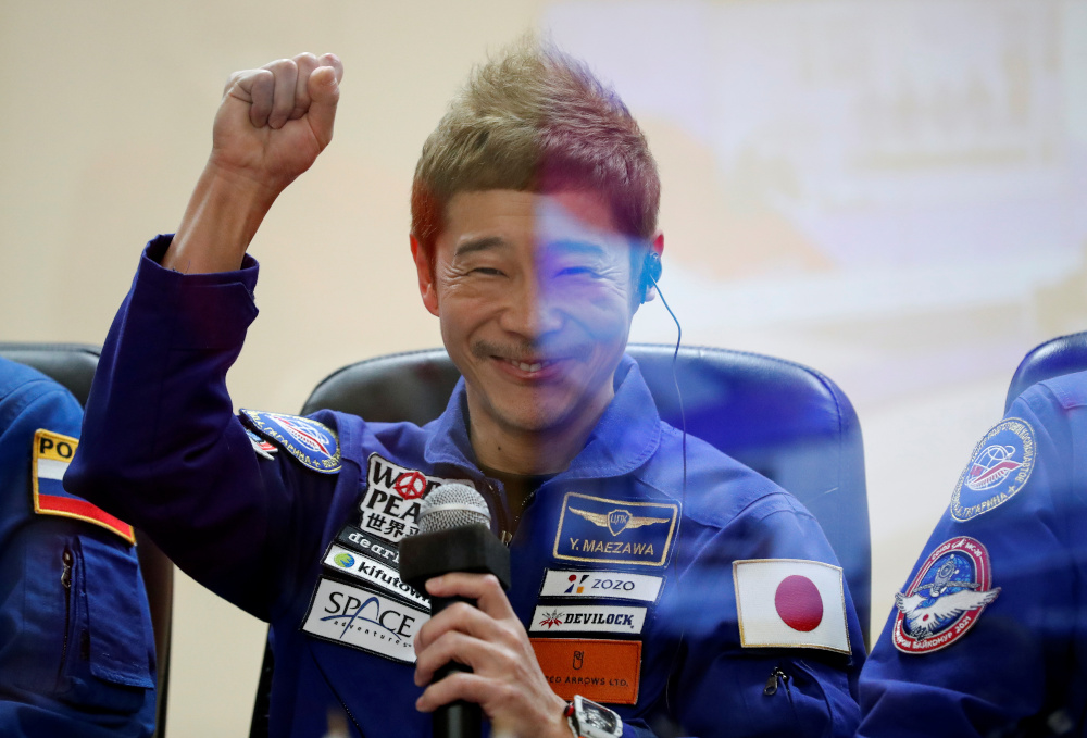 Japanese entrepreneur and space flight participant Yusaku Maezawa gestures behind a glass wall during a news conference in Baikonur, Kazakhstan December 7, 2021. u00e2u20acu201d Reuters pic