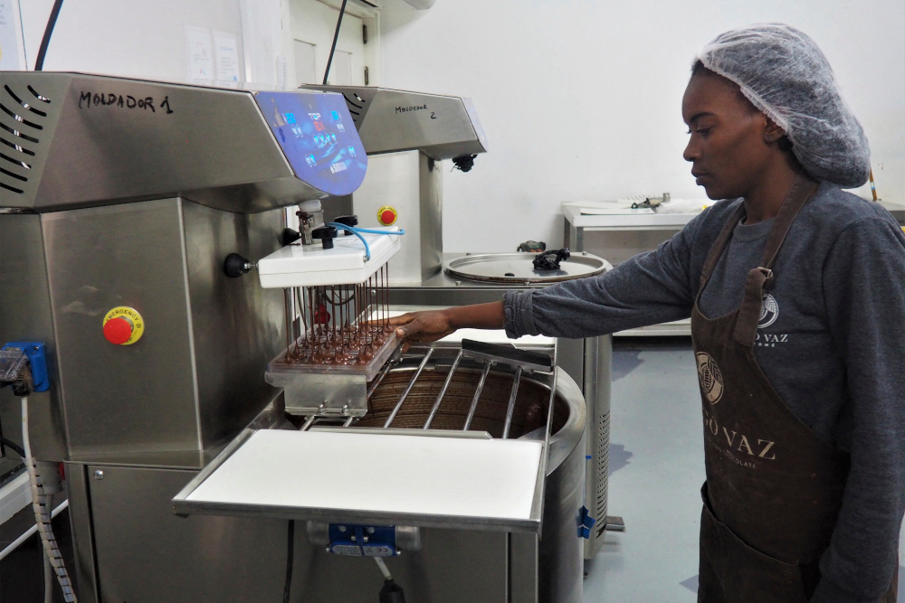 A worker makes chocolate at the Diogo Vaz chocolate factory in Sao Tome, November 18, 2021. — AFP pic