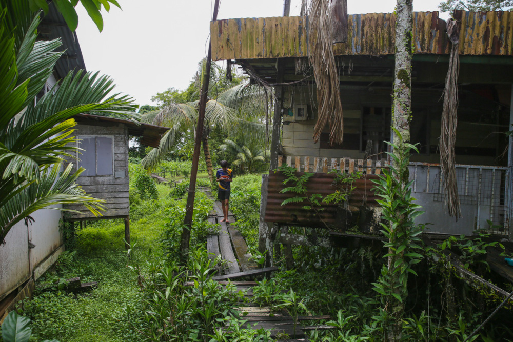 A narrow bridge linking homes on the banks of a tributary of the Sarawak River to the main road of Jalan Nanas Barat is pictured in Kampung Kudei, Satok December 10, 2021. 