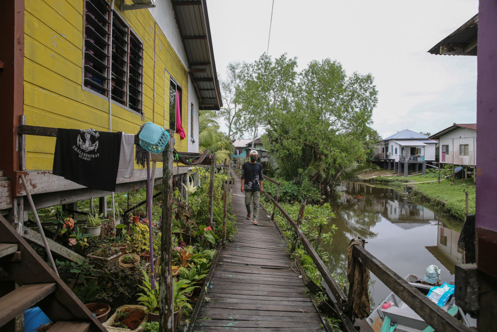 A dilapidated wooden bridge is pictured in Kampung Kudei, Satok, December 10, 2021. 