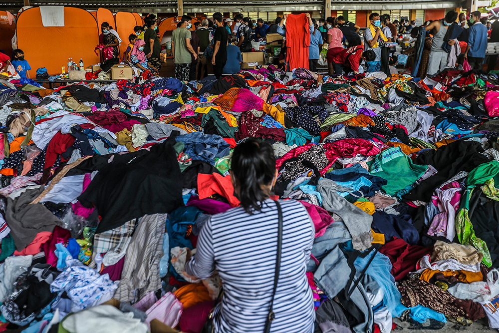 Flood victims pictured taking used clothes at the Temporary Evacuation Centre (PPS) in Taman Sri Muda in Shah Alam, Selangor December 21, 2021.