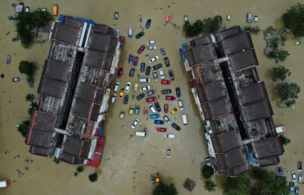 Aerial view shows vehicles and buildings inundated by floods in Shah Alam’s Taman Sri Muda, in Selangor, December 21, 2021. — Reuters pic 