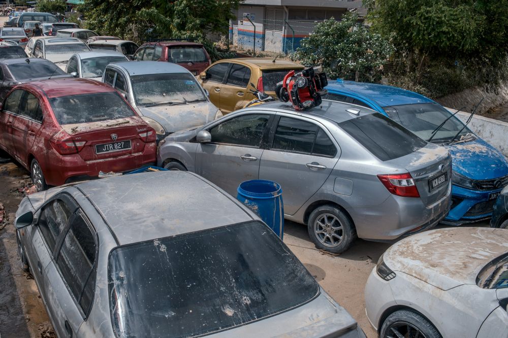 Damaged cars litter the narrow roads of flood-hit Taman Sri Nanding, Hulu Langat December 21, 2021. ― Picture by Shafwan Zaidon