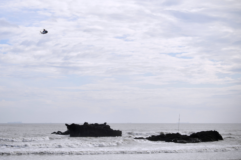 A Malaysian Maritime Enforcement Agency helicopter scours the coastline for signs of victims from a boat that capsized yesterday in waters off Tanjung Balau, Kota Tinggi, December 16, 2021. u00e2u20acu201d Bernama pic 